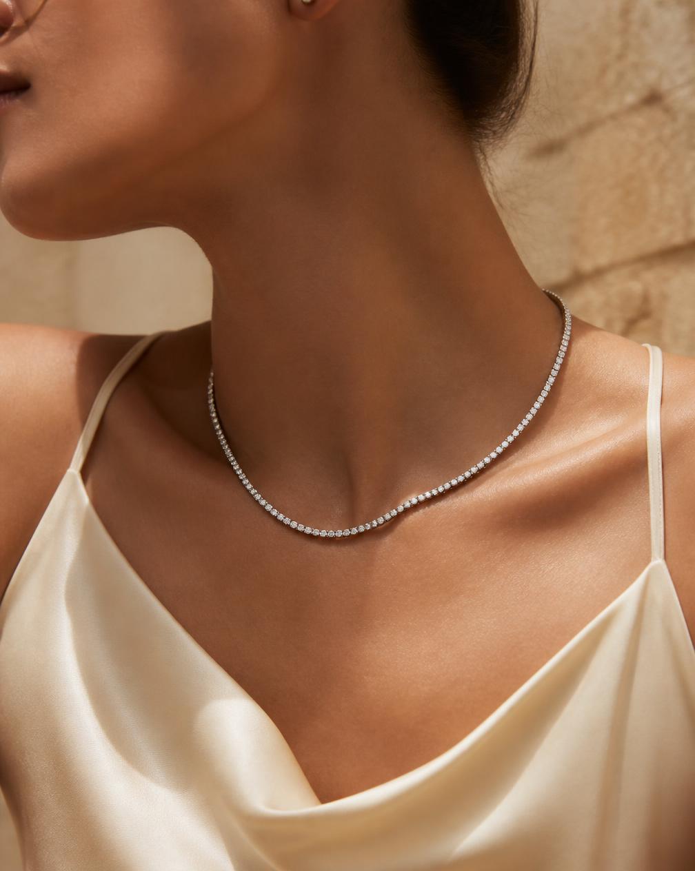 A tennis moissanite necklace worn at the neckline